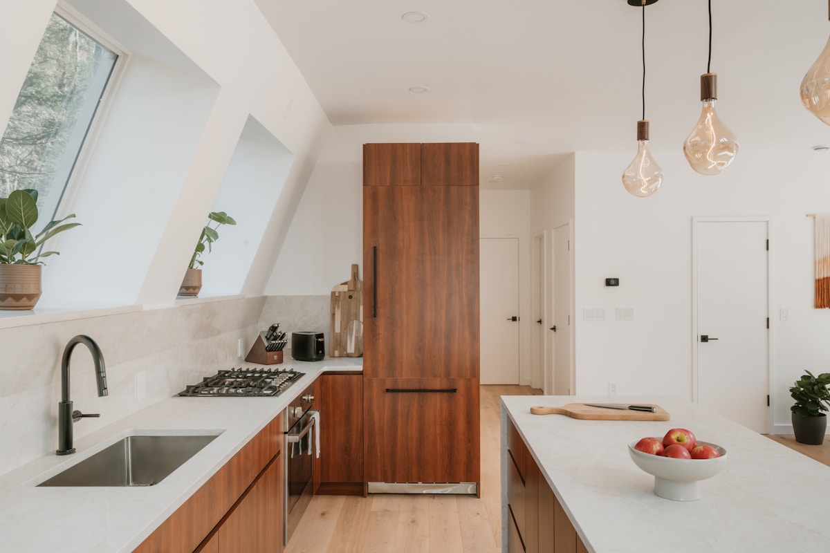 Modern kitchen renovation with white cabinetry and quartz countertops in Tampa Bay home